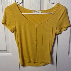 Woman’s juniors yellow button up shirt.